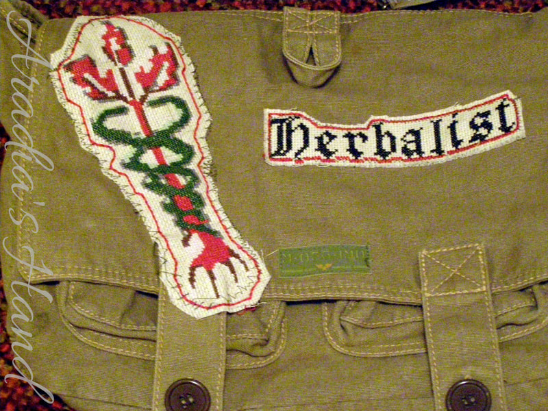 Cross stitched herbalist logo embellished messenger bag
