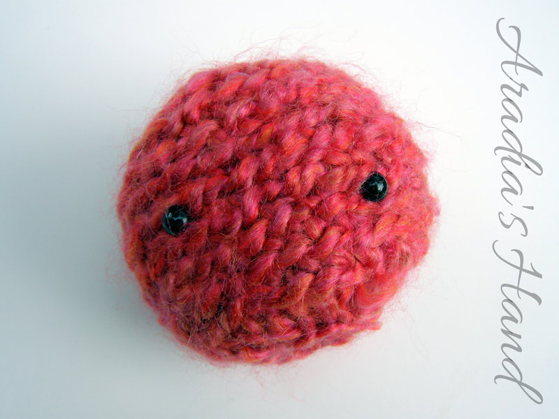 Fuzzy pink crochet amigurumi alien doll